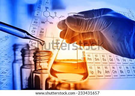 Flask in scientist hand with test tubes 