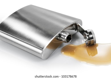 Flask And Spilled Alcohol On The White Background. Isolated.