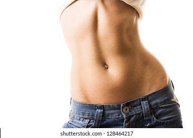 Flat abdomen of young woman in jeans