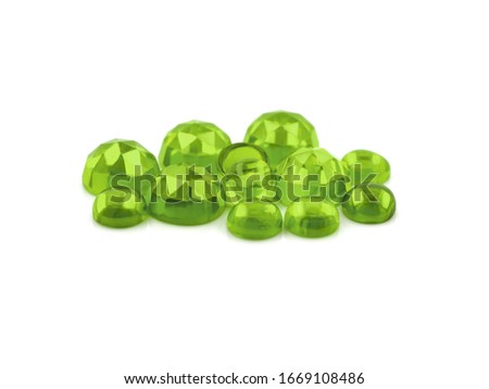 Flat back peridot cabochons on a white background. Rose cut peridot cabochons and smooth polished peridot cabochon.