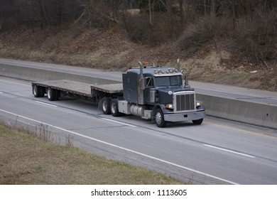 Flat Bed Semi Tractor Trailer Truck on the Highway