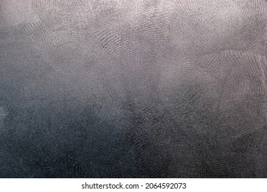 flat black plastic surface with multiple dirty fingerprints, macro photo with focus stacking