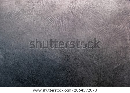 flat black plastic surface with multiple dirty fingerprints, macro photo with focus stacking
