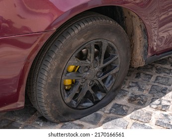 Flat car tire close-up, punctured wheel. Repair of punctured car tires.