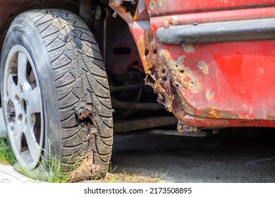 Flat car tire close-up. Shot through the wheel by the police while chasing a lawbreaker. Bullet hole in a wheel tire close-up. Tires with lead bullets stuck in them. Ukraine, Irpin - May 12, 2022