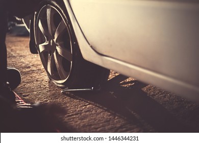 Flat Car Tire  With Tire Maintenance, Damaged Car Tyre At Night.