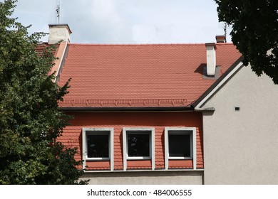 Flat ceramic tile Bieber on the roof and the facade of the building. The image for posting on social networks.