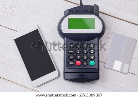 Flat design payment setup is showing smartphone, card terminal and credit card on wooden tabletop. Technology, commerce, fintech, pointofsale, transaction, digital, mobile
