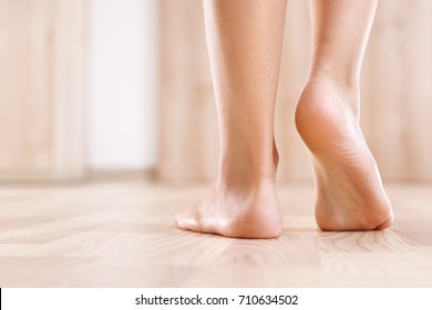 Flat feet. Healthy foot baby. 
Feet of baby's naked against the background of the wooden floor 
