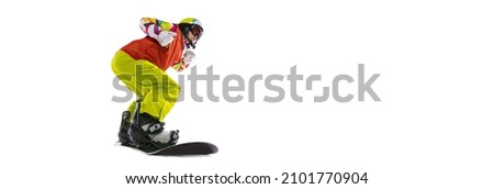 Flat freestyle. Young woman in bright sportswear, goggles and helmet snowboarding isolated on white studio background. Concept of winter sports, active and healthy lifestyle, extreme sports and