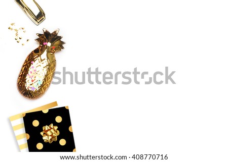 Flat lay. Accessories on the table, woman desk top. View top table, background mock up. Gold pineapple. Gold stapler. 