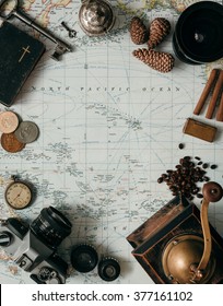 Flat lay adventure vintage gear for exploring or traveling on old map