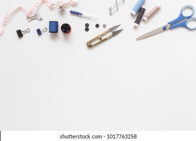 Flat lay aerial image of fashion designer items background concept.Top view sewing accessory or tailor equipment on modern rustic white paper at home office desk studio.Crafting tools in work shop. - Powered by Shutterstock