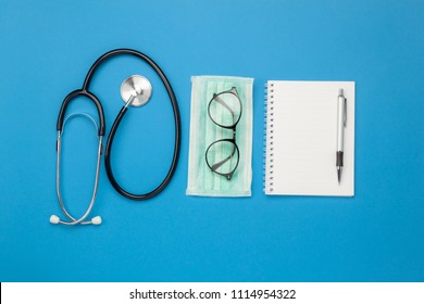 Flat Lay Aerial Of Tools Medical & Healthcare Insurance Background Concept.space For Design.Table Top View Essential Items For Doctor Using Treat & Care Patient In Hospital.Object On Blue Paper.