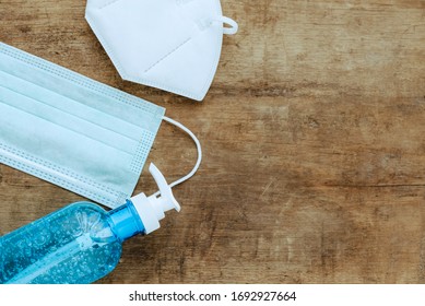 Flat Lay Of Alcohol Gel Or Hand Sanitizer In Pumping Head Bottle) Surgical Face Mask And Pm2.5 Face Mask On Top Wood Table