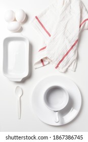 Flat Lay All White Kitchen Still Life, With Spoon, Plate, Towel, Eggs, Platter, And Pot.