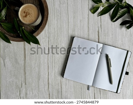 Flat Lay Angled Open Notebook Depicting Relaxing With A Cup Of Coffee And A Book On Wooden Background With Copy Space. Clean Background Ideal for GCSE, SAT, ACT, IB and University Study And Revision Themes 