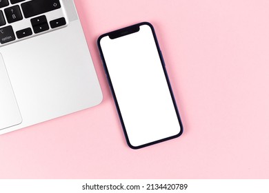 Flat Lay Apple IPhone Screen Mockup, Office Desktop With Laptop, Bright Pink Background. Top View, Copy Space