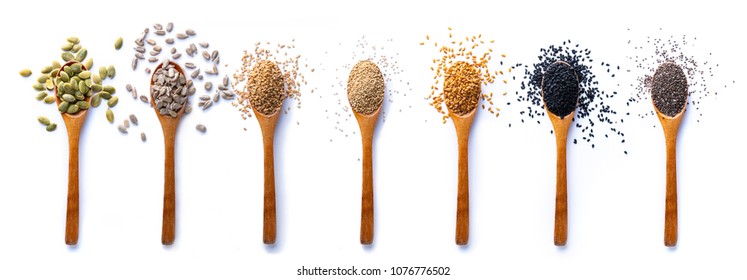 Flat lay of arranged wooden spoons with various healthy seeds in mix on white background. - Powered by Shutterstock