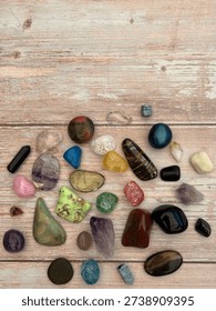 Flat Lay Of Assorted Rainbow Tumbled Crystals And Gemstones On Wooden Background With Copy Space 