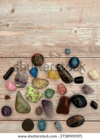 Flat Lay Of Assorted Rainbow Tumbled Crystals And Gemstones On Wooden Background With Copy Space 