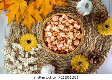 Flat Lay For Autumn, With Bowl Of Flavored Popcorn, Surrounded By Pumpkins, Sunflowers, Maple Leaves And Pine Cones