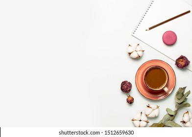 Flat Lay Autumn Composition. Cup Of Coffee, Cotton Flowers, Dry Rose, Eucalyptus, Macaroon Cake, Blank Notebook, Pencil On White Background Top View. Fall Concept. Delicate Female Desktop. 