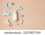 Flat lay with baby sleep accessories with milk bottles, pacifier and toys. Newborn sleeping rules concept