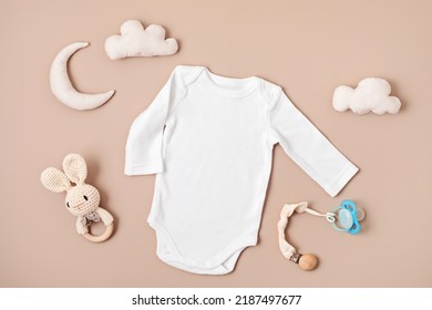 Flat lay with baby sleep accessories with pacifier, pajamas and toys. Newborn sleeping rules concept. Onesie mockup