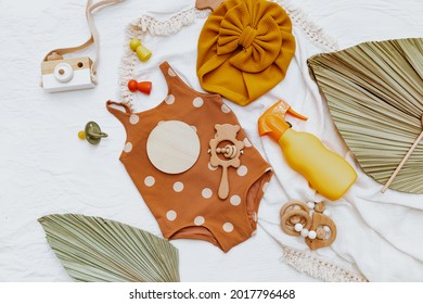 Flat Lay Baby Swimsuit, Beach Accessories And Sunscreen .Plastic Bottle Of Sun Protection. Cream For Kids. 