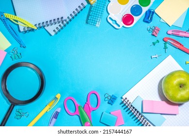 Flat Lay Background With Colorful Educational  Supplies On Bright Blue Background. Back To School Concept. School Backpack With Scissors, Notepads, Pen, Pencils, Supply. Top View, Overhead Copy Space