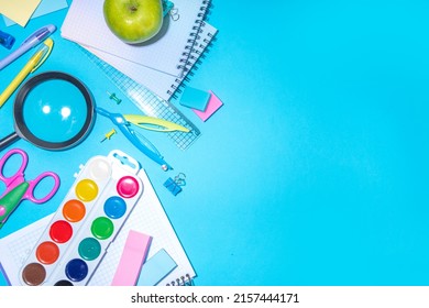 Flat Lay Background With Colorful Educational  Supplies On Bright Blue Background. Back To School Concept. School Backpack With Scissors, Notepads, Pen, Pencils, Supply. Top View, Overhead Copy Space