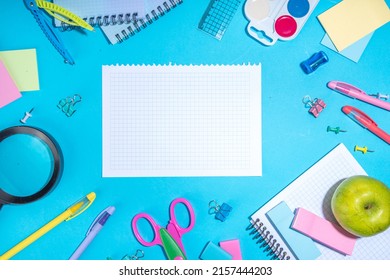 Flat Lay Background With Colorful Educational  Supplies On Bright Blue Background. Back To School Concept. School Backpack With Scissors, Notepads, Pen, Pencils, Supply. Top View, Overhead Copy Space