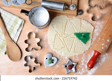 Flat Lay Baking Holiday Cookies Still Life Shot Form A High Angle. Horizontal Format With Cookie Dough, Cutters, Sifter, Flour, Rolling Pin, Cookie Press, Spoon, Towel On Butcher Block Surface.