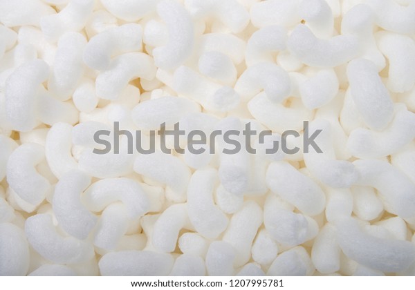 Flat lay of biodegradable packing peanuts.\
Biodegradable packing peanuts are made from natural, nontoxic\
sources, such as wheat and corn starch. They dissolve in water and\
can be put in compost\
piles.