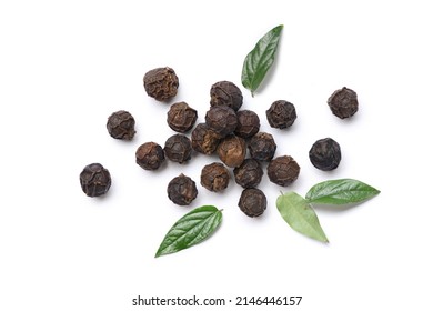 Flat lay of black peppercorns (black pepper) with leaves isolated on white background.
