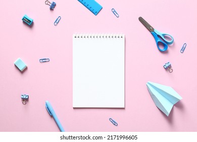 Flat Lay Blank Paper Notepad Mockup With Blue School Supplies On Pink Background. Kids Desk Top View. Back To School Concept.