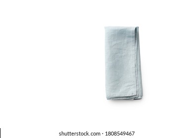 Flat Lay With Blue Linen Rustic Kitchen Napkin Isolated On White Background. Overhead Image Of Folded Cloth For Mockup, Copy Space