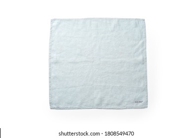 Flat Lay With Blue Linen Rustic Kitchen Napkin Isolated On White Background. Overhead Image Of Folded Cloth For Mockup, Copy Space