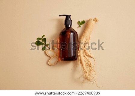 Flat lay of a bottle with empty label and Korean ginseng decorated on beige background. Products display mockup