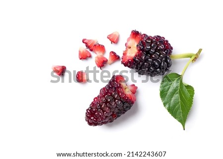 Flat lay of broken mulberry fruit isolated on white background.