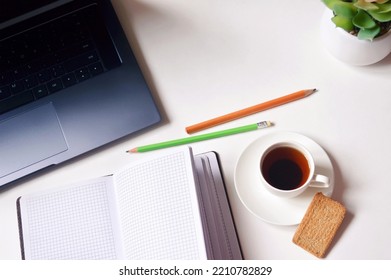 Flat Lay Business Background, Top View Photo. Laptop, Open Paper Notebook And Coffee Cup