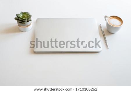 Flat lay business feminine workplace with  laptop, coffee and green eucalyptus. White colors. Minimalism. Home office. Top view. Copy space for text