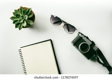 Flat lay camera with notebook