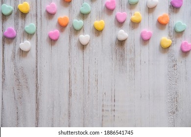 Flat Lay Candy Hearts Pattern - Pastel Rainbow Conversation Heart Candy Design For Valentine's Day. Top View Sweet Decor For Easter.