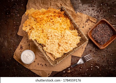 Flat lay of cheese chips snack served with white sauce