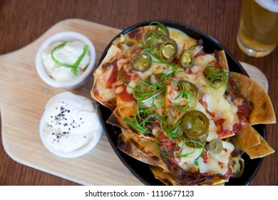 Flat Lay Cheesy Nachos With Sour Cream