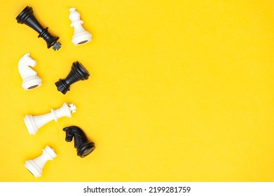 Flat Lay Of Chess Pieces On A Yellow Background, Copy Space. Chess Game As A Symbol Of Success