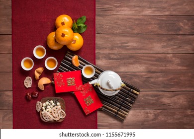 Flat Lay Chinese New Year Food And Drink On Wooden Table Top. Texts Appear In Image: Prosperity, Spring. Text Space Image.