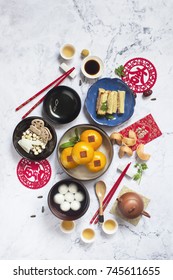 Flat Lay Chinese New Year Food And Drink Table Top Shot Still Life. Translation On Text Appear In Image: Prosperity And Good Luck.